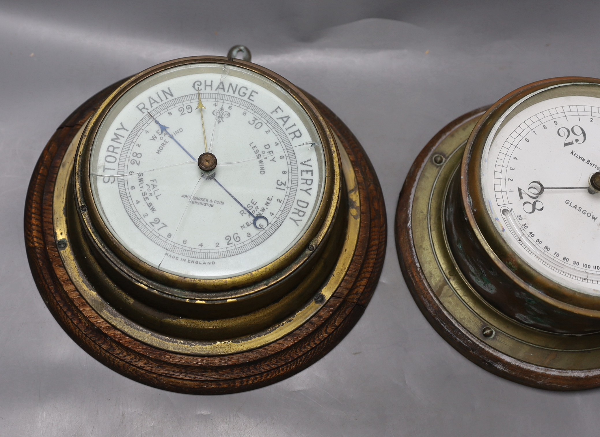 A John Barker & co brass bulkhead barometer and another by Kelvin Bottomly & Baird ltd., diameter 27. 5 cm